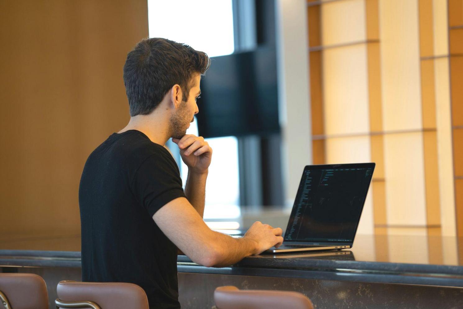Financial analyst reviewing valuation multiples on computer screens